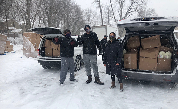Food Brigade volunteers distribute food in the snow