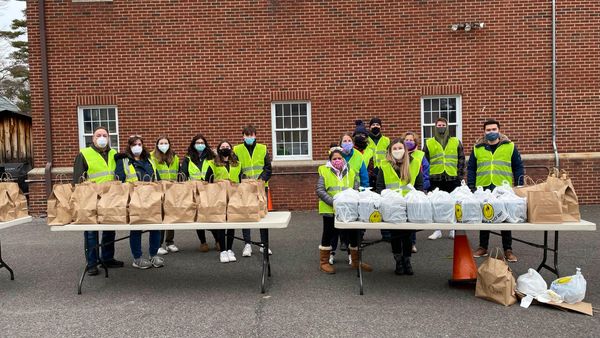 Food Brigade volunteers distribute prepackaged restaurant meals to those in need