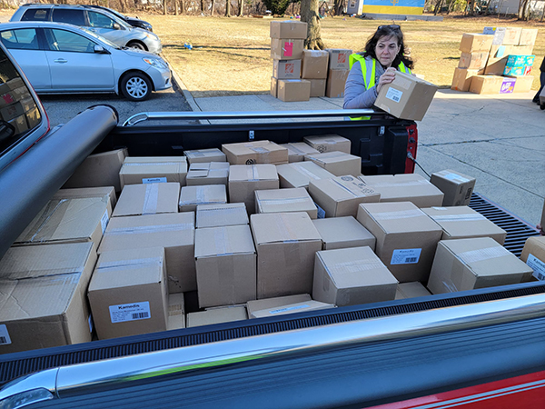 Food Brigade President Karen DeMarco unloads a truckload of supplies for delivery to Ukraine